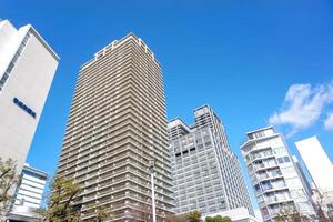 Osaka City, Japan, 2023 - Landscape of city building on bright blue sky with clouds background. photo