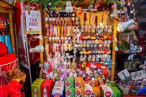 Osaka City, Japan, 2023 - Japanese souvenirs hang and sell in Kuromon ishiba street market and gift shop, Osaka, Japan. photo