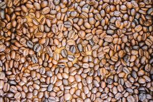 Closeup roasted coffee beans fit on screen background and wallpaper. photo