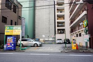 Osaka City, Japan, 2023 - Coin operated car deposit services are very popular in Japan. Because the Japan law allows citizens to have cars, needing to have space for their own parking. photo