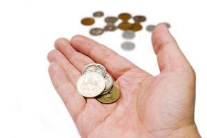 Japan Yen currency coins on hand with blurry coins isolate on white background and make with paths. photo