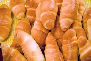 Top view and closeup of bun on shelf in bakery shop. photo