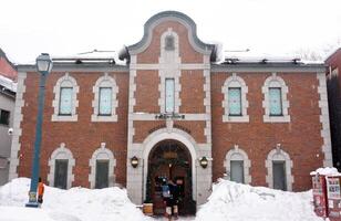 Otaru City, Japan, 2023- Japanese restaurant and building in European style of Otaru Sakaimachi shopping street on winter snow day. photo