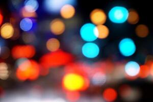 Abstract colorful blurred and bokeh reflection lighting on the road and city night life. photo