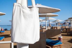 Mockup shopper handbag hanging on the beach photo