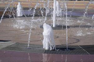 Splashes of a fountain in the park photo