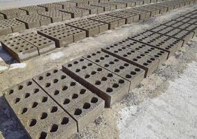 Cinder blocks lie on the ground and dried. on cinder block production plant. photo