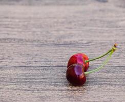 Cherry berries on a wooden background. Ripe red sweet cherry photo