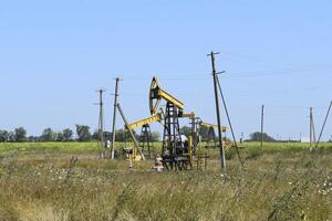 Pumping unit as the oil pump installed on a well photo