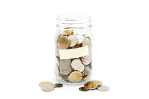 Thai Baht coins in a glass jar. Business and finance concept. photo