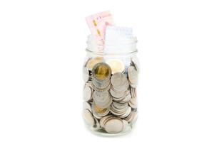 Thai Baht banknotes and coins in a glass jar. Business and finance concept. photo