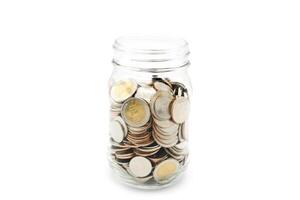 Thai Baht coins in a glass jar. Business and finance concept. photo