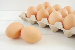 Fresh chicken eggs on white wooden table photo