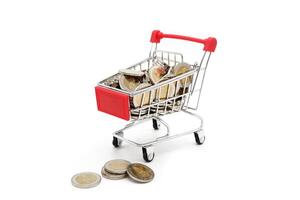 Red miniature shopping cart filled with new 10 Thai Baht coins, isolated on white background. Business concept. photo