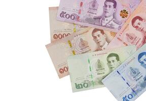 Pile of new Thai Baht banknotes, isolated on white background. Business and finance concept. photo