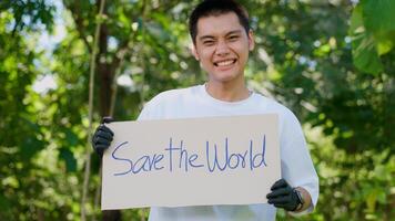 Happy young Asian students diverse volunteers hold a campaign sign for Save the World, The concept of environmental conservation on world environment day, recycling, and charity for sustainability. photo