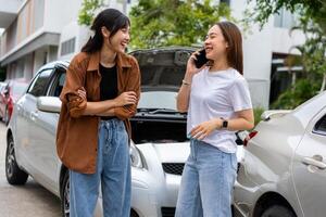 Two Drivers using a smartphone to exchange phone numbers and social media after a car accident. Concept of claim insurance for a car accident online after send photo and evidence to insurance company