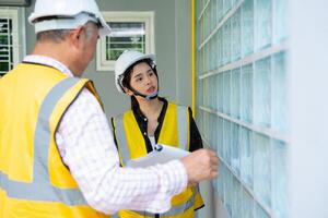 Senior home inspector checking home defects and teaching young engineers, before handing it over to client. Young engineers learn home inspection with Senior, Real estate, and renovation concepts. photo