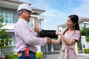 Happy homeowner stand in front of contractor and shake hand, handyman holding clipboard and after checking details before renovations home, house improvement interior, Interior design photo