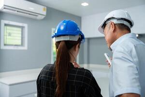 Senior home inspector checking home defects and teaching young engineers, before handing it over to client. Young engineers learn home inspection with Senior, Real estate, and renovation concepts. photo