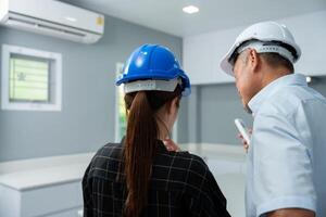 Senior home inspector checking home defects and teaching young engineers, before handing it over to client. Young engineers learn home inspection with Senior, Real estate, and renovation concepts. photo