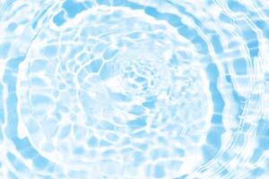 Water surface. Bluewater waves on the surface ripples blurred. Defocus blurred transparent blue colored clear calm water surface texture with splash and bubbles. Water waves with shining pattern. photo