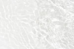 Water surface. Bluewater waves on the surface ripples blurred. Defocus blurred transparent blue colored clear calm water surface texture with splash and bubbles. Water waves with shining pattern. photo
