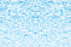 Water surface. Bluewater waves on the surface ripples blurred. Defocus blurred transparent blue colored clear calm water surface texture with splash and bubbles. Water waves with shining pattern. photo