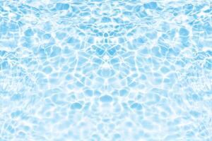 Water surface. Bluewater waves on the surface ripples blurred. Defocus blurred transparent blue colored clear calm water surface texture with splash and bubbles. Water waves with shining pattern. photo