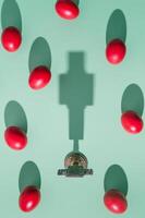 Creative Easter holiday layout made with Christian Cross and red colored Easter eggs on green background. Minimal Easter concept. An original background image with lights and shadow.  Flat lay. photo