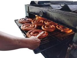 Hot sausages on the grill. Hot stove. Isolated on white background. photo