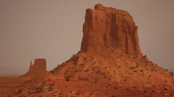 A large rock formation in the middle of a desert video