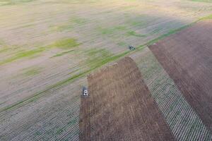 Top view of the tractor that plows the field. disking the soil. Soil cultivation after harvest photo