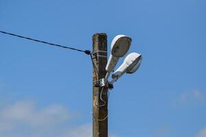 Lanterns on the pole. A pillar of power line with lighting fixtures photo