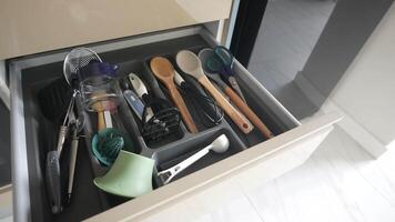 Close up of messy kitchen utensil drawer. video