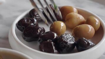 Collection of black and green olives with leaves. video