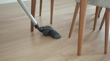 woman cleaning floor dust with vacuum cleaner. video