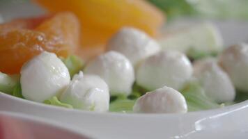 Many fresh white mozzarella cheese balls in a bowl video