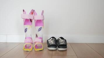 Child legs orthosis shoe on floor video