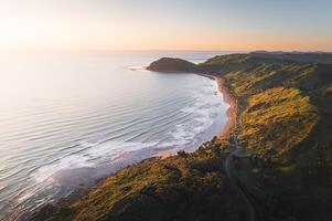 Beautiful Sunset at the Ocean Beach, New Zealand. Inspiring natural and travel background photo