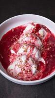 A plate of cheese fritters in cream-cherry sauce top view, flat lay on dark background photo