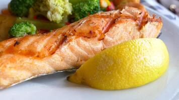 salmon fish served with fresh vegetable on a plate video