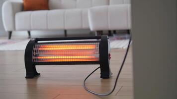 Modern electric infrared heater in living room, closeup video