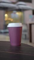 red color Blank take away kraft coffee cup on table , video