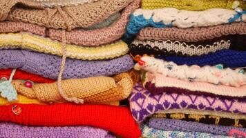 Bunch of knitted warm sweaters with different knitting patterns. video