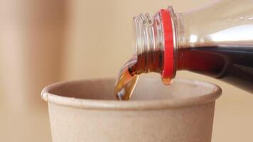 pouring soft drinks from bottle in paper cup video