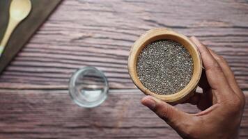 top view of holding a chia seed in a container , video