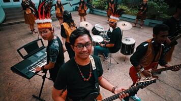 Indigenous musicians performing with traditional instruments in an outdoor setting. video