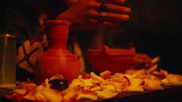 a shaman is performing a ritual with spells and offerings on a table video