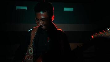 silhouette de une guitariste avec une embrasé rouge étape lumière video